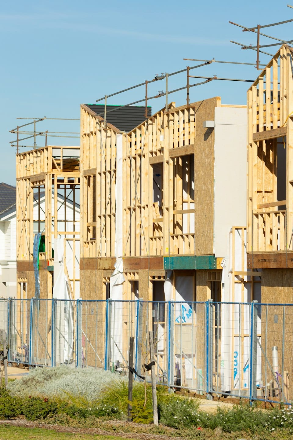 Wooden skeletons of new residential buildings under construction.